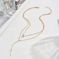Double-layered gold Y-necklace featuring a sparkling zircon stone and a sleek vertical bar pendant - Gold
