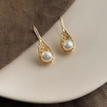 Macro detail of French vintage baroque pearl drop earrings with textured golden lava frames - Style 24