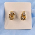 Elegant gold multi-loop stud earrings displayed on a soft pink card with blue silk - 15x24 Style