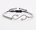 Detail of silver infinity symbol bracelet with zircon stones and adjustable black pull cord - White Gold Copper Beads + Black Rope