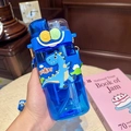 Close-up of blue dinosaur children water bottle with a push-button straw and cute design - Dark Blue Dino