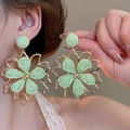 Close-up of mint green woven flower earring with gold hollow metal frame on model - Light Green Woven Hollow Metal Flower (10# Silver Earring Post)