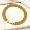 Detail of gold mesh choker with rhinestone clasp on a beige tray with white fabric background - YS855 Gold Necklace