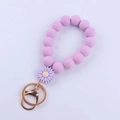 Detailed view of light purple silicone daisy beaded keychain with golden metal clasp - Purple