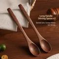 Set of 2 long handle wooden stirring spoons with natural dark grain on a rustic table - Long Handle Stirring Spoon (Set of 2)