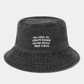 Close-up of washed black denim bucket hat with white text embroidery and metal eyelets - Army Green