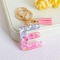 Pink glitter resin letter E keychain with stylish tassel and golden ring accessory - Letter E / Pink