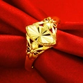 Golden fan-shaped ring with bow and flower accents on dark red silk fabric background - Fan Radial Pattern (J111520)