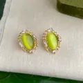 Orecchini in oro con pietra occhio di gatto verde oliva e accenti di zirconi - 713 Occhio di gatto in vetro traforato