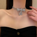 Primo piano del girocollo in argento con fiocco di strass sulla clavicola - Choker Con Fiocco di Strass d'Argento