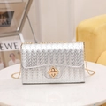 Silver woven crossbody bag with gold metallic turn-lock and elegant chain strap - Silver