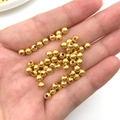 Golden plated CCB round beads held in hand for size comparison in DIY jewelry making - Gold Beads (14084)