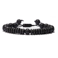 Detailed view of black lava rock beads and adjustable braided rope on the bracelet - Woven Style / Black