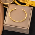 Elegant gold bamboo joint open bangle bracelet displayed on a luxury jewelry box - Gold