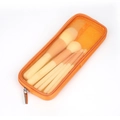 Portable orange mesh makeup pouch with matching cosmetic brushes set on white background - Orange