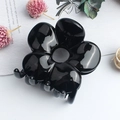 Glossy black flower-shaped hair claw clip with a minimalist five-petal design - Glossy Black