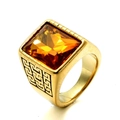 Detailed macro view of gold-plated square amber gemstone ring with Greek key engraving - Gold Yellow Gemstone
