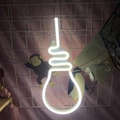 Bulb-shaped LED neon sign with warm white light and USB plug on a wall grid - 1-2W / Bulb White