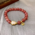 Macro shot of artificial strawberry crystal beads with gold Fu charm and gourd pendant - 60# Red Gourd Style