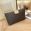 Brown crossbody bag with gold clover print and adjustable leather strap on wooden desk - Khaki