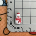Mini resin snowman with red hat and scarf shown on a ruler measuring about 2cm - Snowman