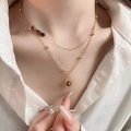 Close-up of layered gold necklace with brown beads and sun pendant on a model - 35# Necklace - Gold-Brown (Double Layer Sun Pendant Style)