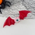 Halloween red bat wings hair clip with eyeball detail on black spider web background - Red Eyeball