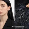 Detail of 5cm oversized silver hoop earrings showing model wear and scale - 5cm / Minimalist Hoop / Silver