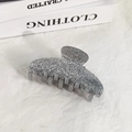 Close-up of a sparkling silver glitter hair claw clip on a minimalist white backdrop - Silver
