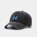 Detailed close-up of a blue butterfly embroidery on a vintage washed grey cotton baseball cap - Butterfly Black