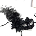 Elegant black ostrich feather masquerade mask with flower and sequin details on white background - Black