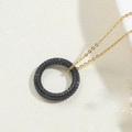 Detailed shot of 14K gold plated circular pendant featuring micro-set dark blue stones - Royal Blue