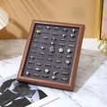 Detailed view of luxury walnut wood ring tray with gray velvet lining and silver rings - Walnut Frame with Grey Interior