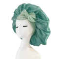 Mint green satin sleep bonnet with a large bow detail shown on a white mannequin head - Medium Single Layer Ribbon / Grass Green