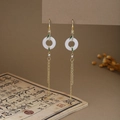 Detail of Chinese tassel earrings with white jade rings, green leaves and golden chains - Jade Ring Green Enamel Long Chain Tassel Style (E6410)
