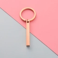Detailed view of a rose gold bar keychain on a minimalist pink and grey background - Rose Gold (MP424)