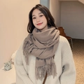 Elegant khaki cashmere-feel scarf with long tassels worn by a smiling model - Khaki