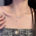 Silver necklace with butterfly charms and pearls shown on model's neckline - Double Butterfly Pendant Clavicle Chain (X3219)