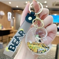 Creative gray moon bear keychain with gold hardware and liquid glitter stars star sequins - Moon Astronaut