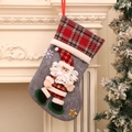 Detail view of a large Christmas stocking with 3D Santa Claus and red plaid cuff decor - Santa Claus