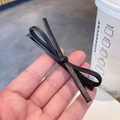 Minimalist black leather bow hair clip with premium PU texture and metal snap base - Black