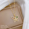 Close-up of gold butterfly necklace with colored cubic zirconia on a jewelry box - Gold Butterfly Pendant (E116钛钢链条铜吊坠)