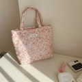 Close-up of pink floral quilted tote bag featuring a simple wish label on a white surface - Pink Ditsy Floral