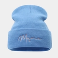 Detailopname van blauwe gebreide muts met roze Mama-borduring en hartjespatroon - Lichtblauw
