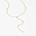 Minimalist gold-plated Y-shaped necklace with five bezel-set zircon stones on white background - Gold