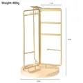Rotating golden metal jewelry stand with wooden base for necklace storage 35cm high - Gold