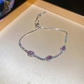 Detailed macro of pink zircon silver bracelet featuring three oval stones and slider clasp - Silver-Pink
