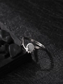 Detail of silver stainless steel luminous ring on black stones with dark artistic lighting - Irregular Style (NR299)