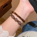 Elegant beaded bracelet set featuring dark brown wood and translucent grey crystal beads - Brown/Wood Grey Beads