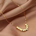 Elegant gold titanium steel necklace with curved cubic block pendant on silk background - X464 Gold Curved Cubes